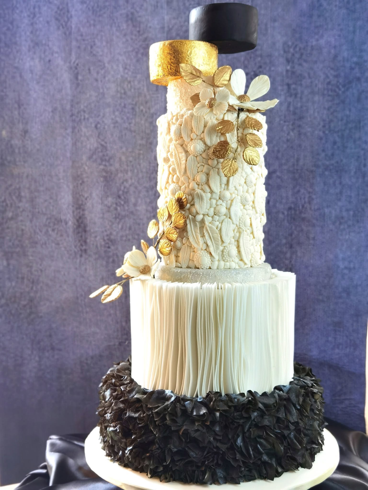 An elegant black, white and gold couture tiered cake by 21Treats